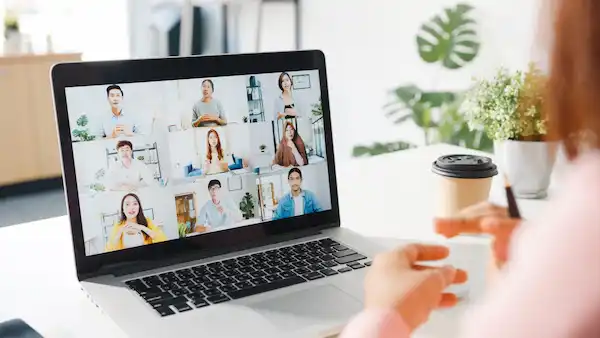 young asia businesswoman using laptop talk colleague about plan video call meeting while work from home living room min scaled 1 HR Service - HR Made Easy Whitecollars for HR Services