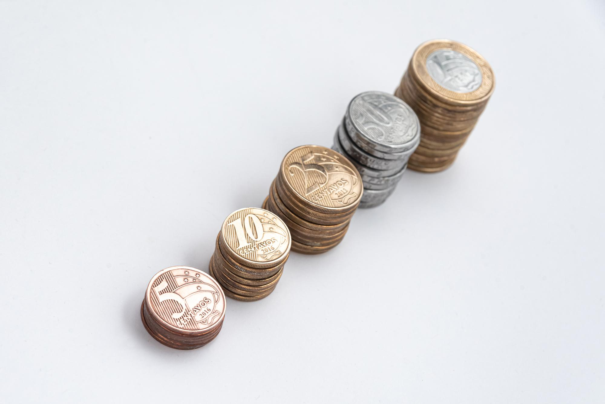 Many columns of coins that illustrate the pay rise as a percentage of current salary