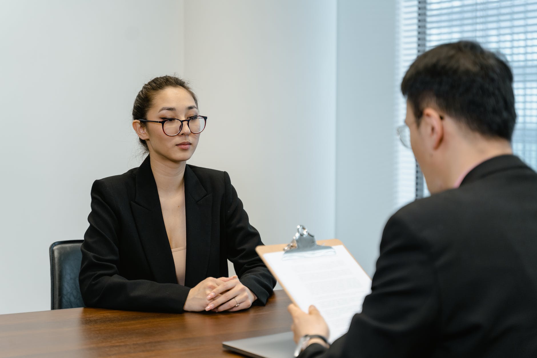 A recruiter that records notes during a competency based interview with a candidate