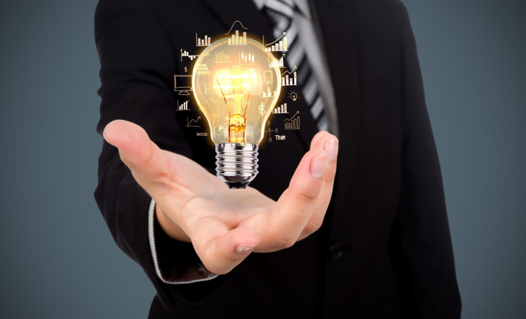An entrepreneur’s hand with a light bulb that illustrates a new idea.